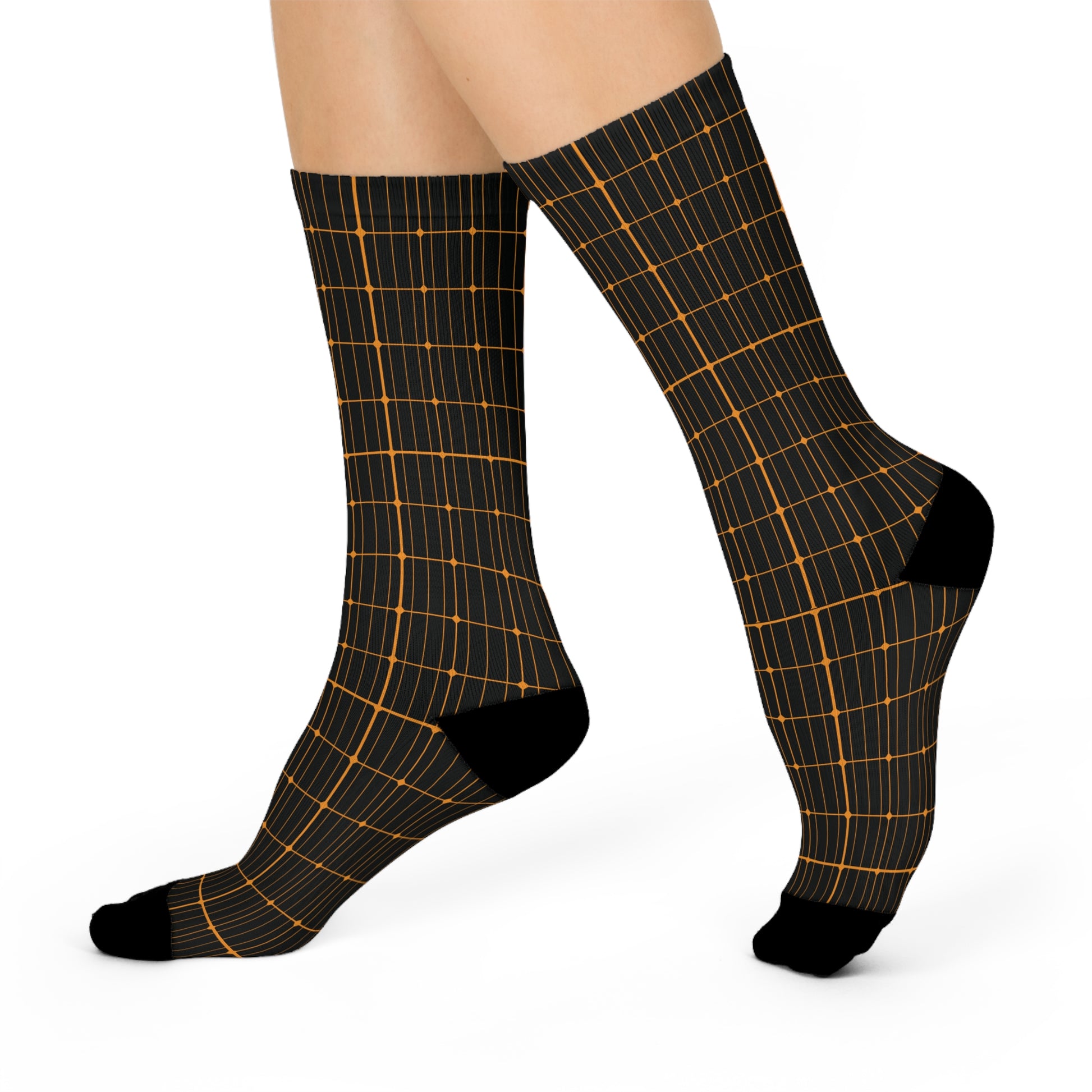 Black socks with solar grid pattern worn by a person on a white background