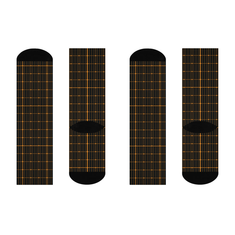 Four black socks with solar grid pattern on a white background