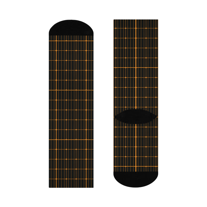 Black socks with solar grid pattern on a white background