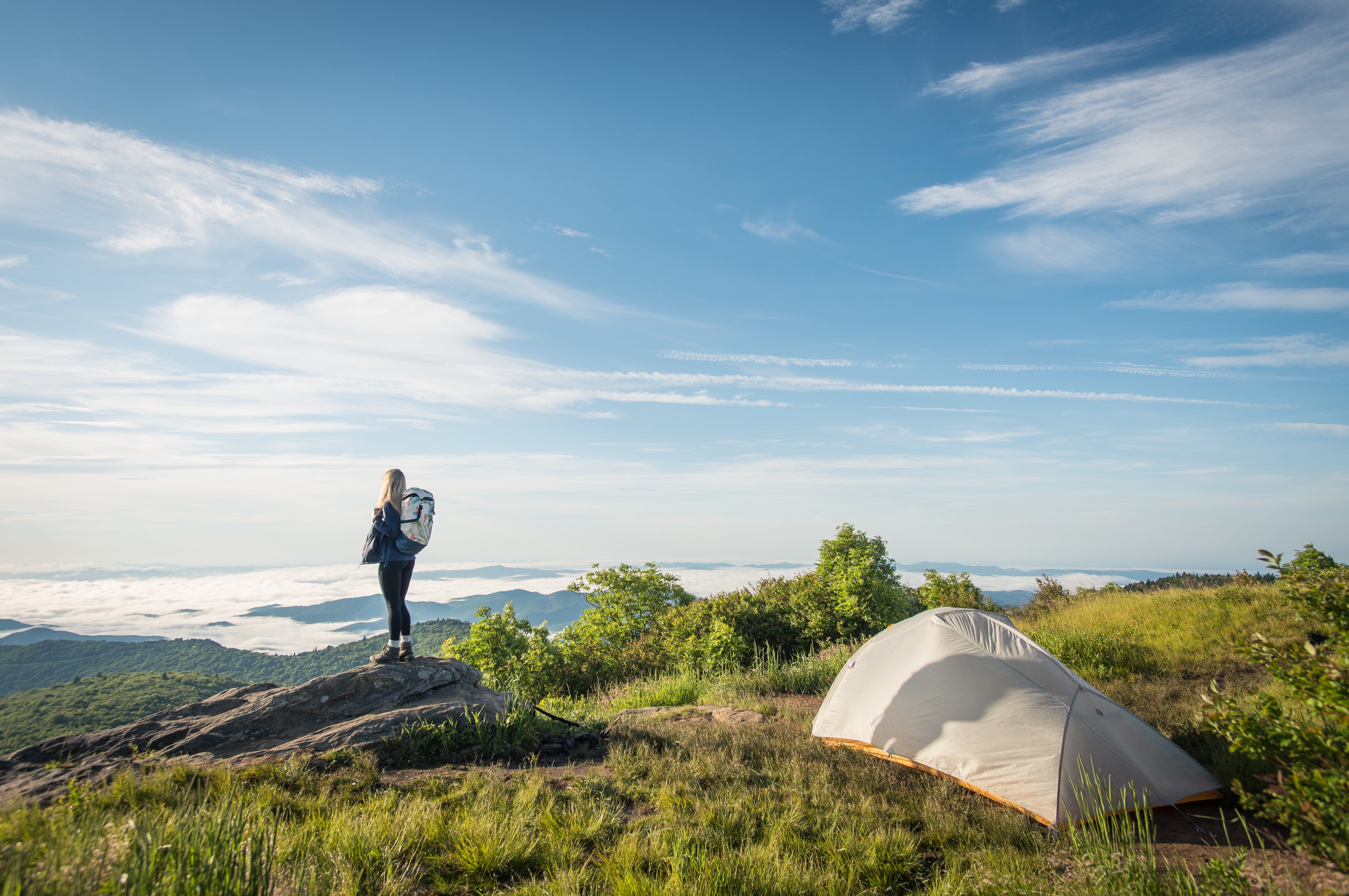 Woman camping on mountain top